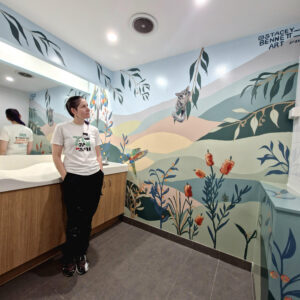 Artist Stacey Bennett looking at mural at Jimboomba Central parents room